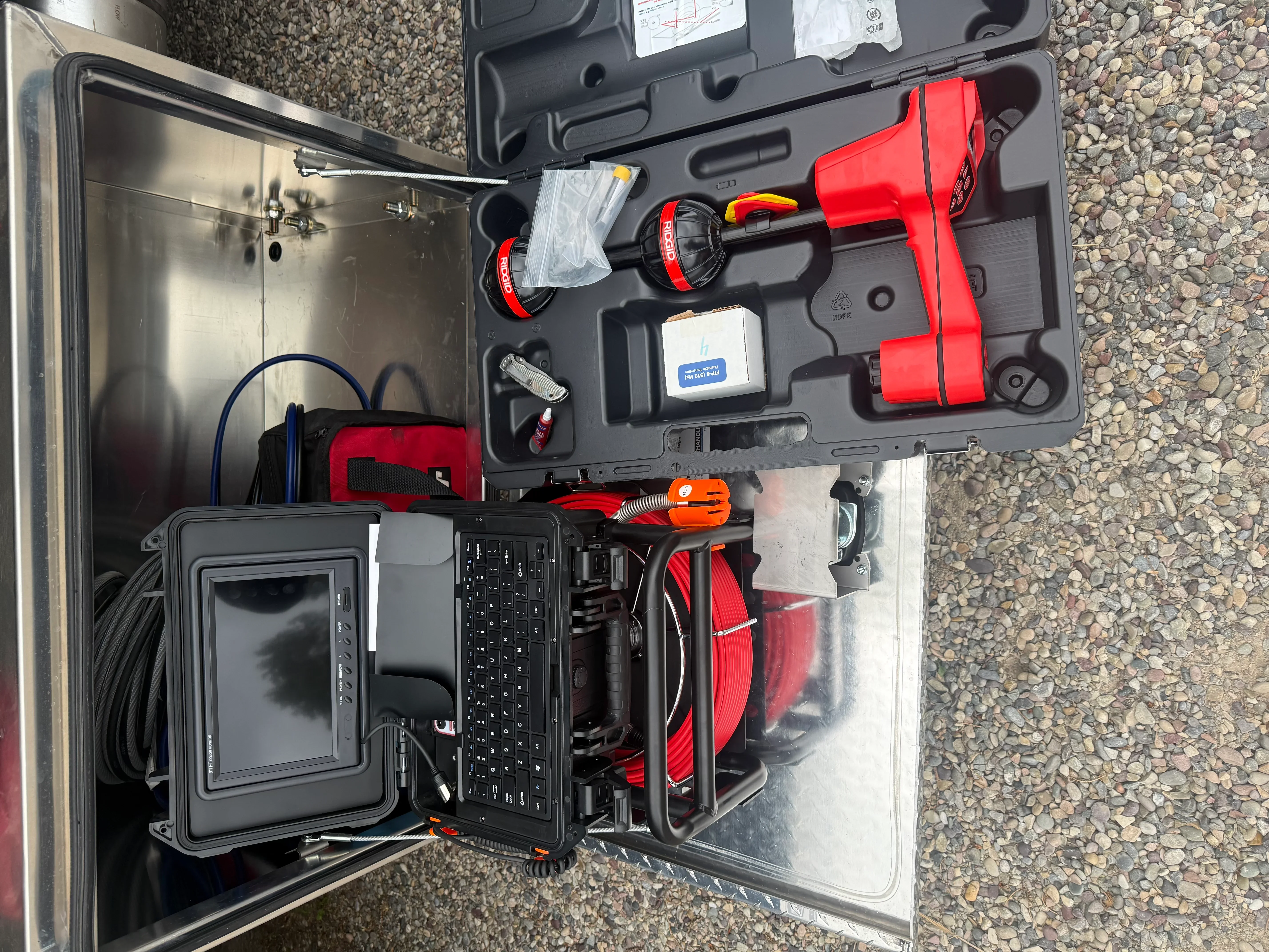 Septic inspection camera system with monitor, cable reel, and diagnostic tools in protective cases